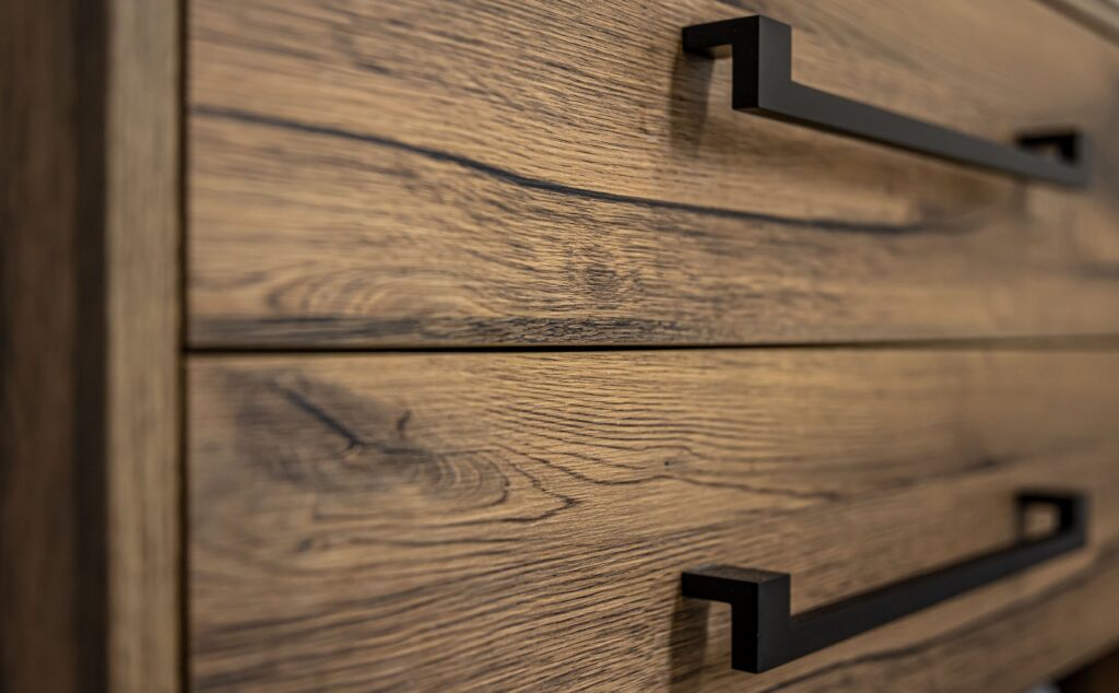 close-up-modern-dark-wood-furniture-with-black-handles-min